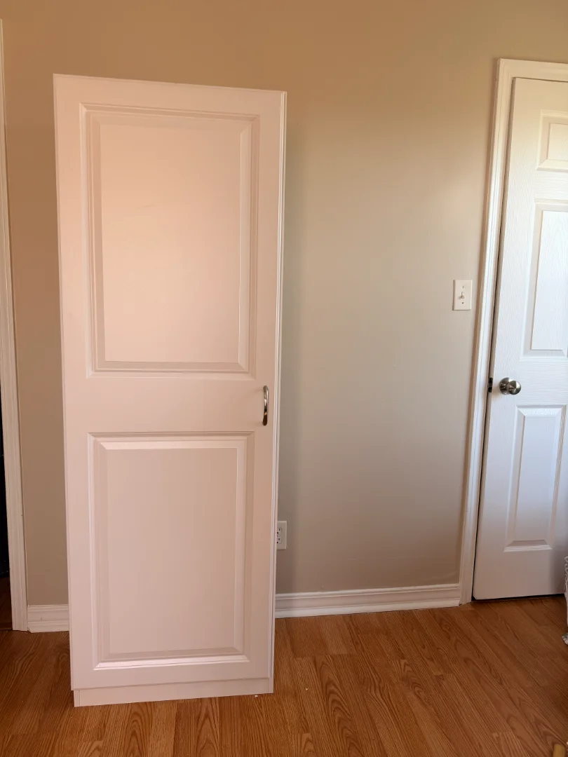 White tall multi-purpose storage cabinet fully assembled inside a home in Spring Hill, Tennessee by Boxed2Built