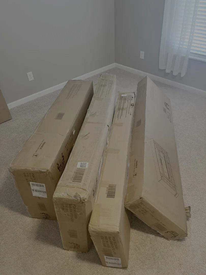 Unopened flat-pack furniture boxes before assembly in a Spring Hill, Tennessee home